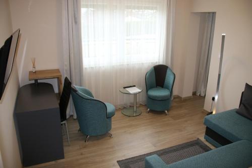 a living room with two chairs and a table at Relax & Therapy in Bad Tatzmannsdorf