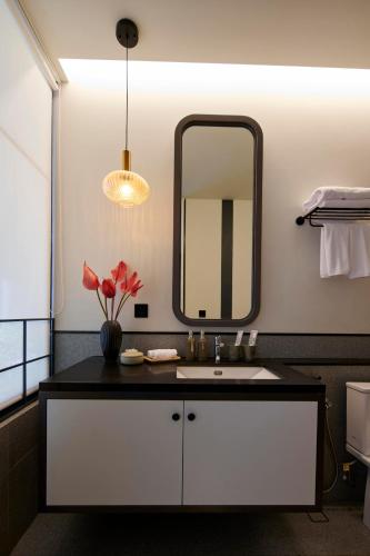 a bathroom with a sink and a mirror at Adamare Villa Umalas in Kerobokan