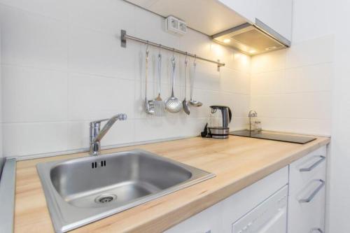 a kitchen with a sink and a counter top at Apartment Beti comfort - 300m from beach in Betina