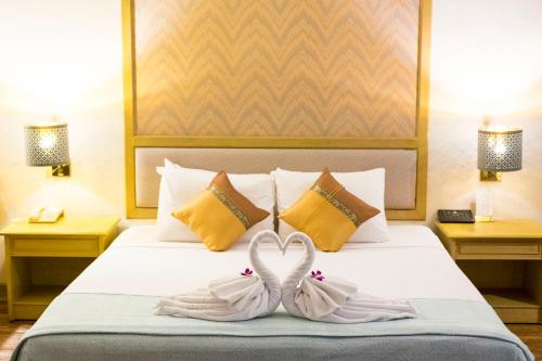 two towels on a bed in a hotel room at โรงแรมมุกดาหารแกรนด์ 