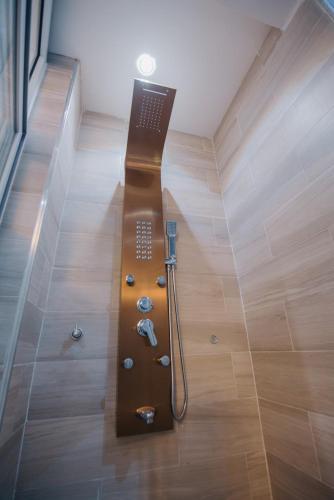 a bathroom with a shower in the middle of a room at Big chill stays (luxe suits) in Maijaw