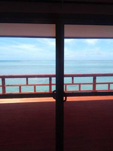 a view of the ocean from a window at Le Uaina Beach Resort in Falepuna