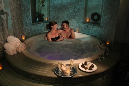 a man and a woman sitting in a bath tub at The Inn and Spa at East Wind in Wading River