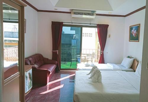 Ένα ή περισσότερα κρεβάτια σε δωμάτιο στο the L Hua Hin