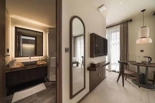 a bathroom with a sink and a mirror at Su Casa Phu Quoc Long Beach in Phú Quốc