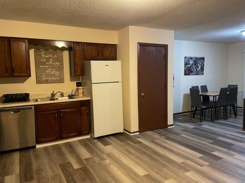 a kitchen with a refrigerator and a table with chairs at ~Como's Finest ~A Home Away From Home ~Sleeps 10 ~ in Columbia