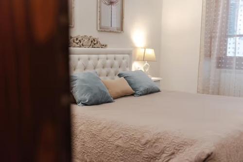 a bedroom with a bed with two pillows on it at LA CASA DEL FALEGNAME in Laterina