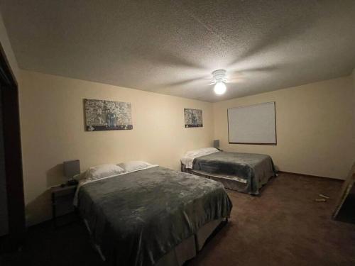 a bedroom with two beds and a white board on the wall at ~Como's Finest ~A Home Away From Home ~Sleeps 10 ~ in Columbia