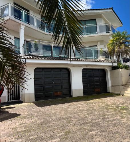 two garage doors in front of a building at Silver Gates BnB in Mbabane