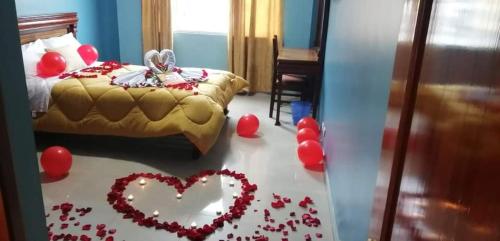 - une chambre avec un lit et des cœurs à l'étage dans l'établissement Hostal zamorano, à Quito