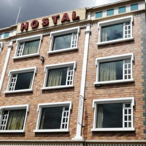 a brick building with a hotel sign on it at Hostal zamorano in Quito