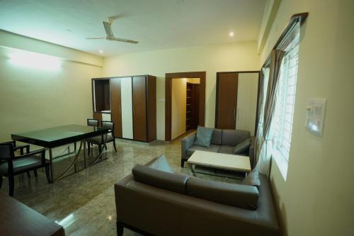 a living room with a couch and a table at Sri Govindham Home Stay in Tirupati