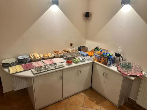 a kitchen with a counter with food on it at Pension Robin in Jáchymov