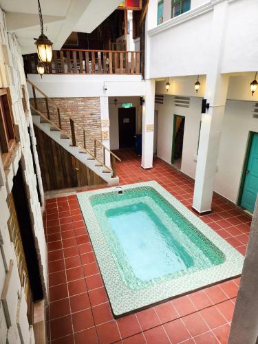 an indoor swimming pool in a building with stairs at Bestow Boutique Hotel in Kuala Lumpur