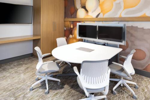 a conference room with a table and chairs and a tv at The Westin Jackson in Jackson
