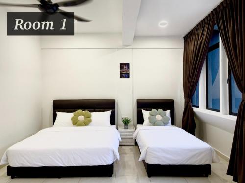 2 camas en una habitación con paredes y ventanas blancas en The Urban Lodge 1 en Kuala Terengganu