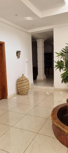 a room with a white wall and a basket on the floor at HomeVilla in Tranquil