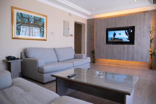 a living room with a couch and a table at Terrace Furnished Apartments - Mahboula in Kuwait