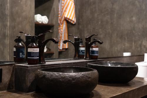 a bathroom counter with two sinks and a mirror at Bombora Medewi in Pulukan