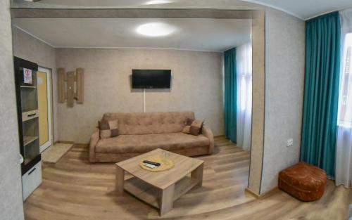 a living room with a couch and a table at Hotel Rade 1 in Vratsa