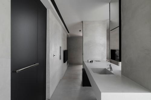 a white bathroom with a sink and a mirror at Yamaki x Shaoguang Stay in Yuchi