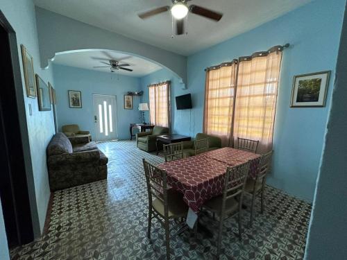 a living room with a table and chairs and a couch at Best Surfers Beach just a few block down, Arecibo Main House in Arecibo