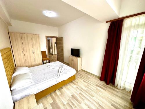 a bedroom with a bed and a television in it at Summerland Seaview Apartments in Mamaia