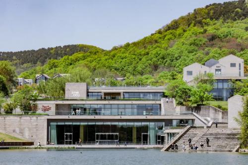 a building next to a body of water at The Sifang Hotel Nanjing, Autograph Collection in Nanjing