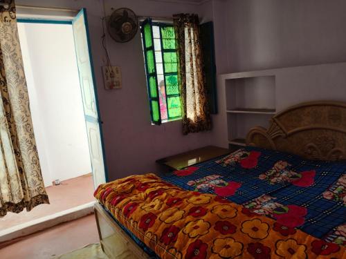 a bedroom with a bed and a stained glass window at Hotel Old Moon Cafe in Pushkar