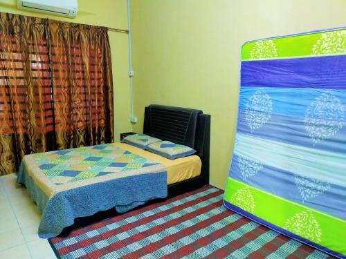 a small room with two beds and a window at RIZQI HOMESTAY Sungai Siput with Wifi! Islamic Guest Only! in Kampong Rimba Panjang