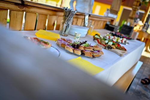 a table with two plates of food on it at Casa Potcovarului in Drăguş