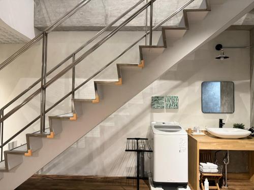 a bathroom with a staircase and a sink at Hotel art rock in Takamatsu