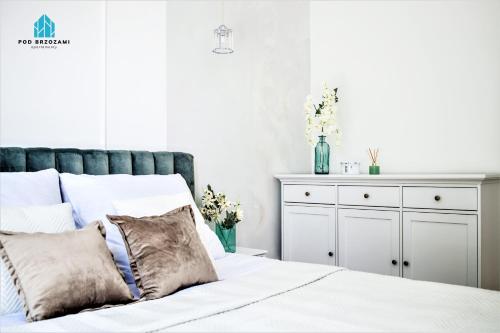 Postel nebo postele na pokoji v ubytování Pod Brzozami Apartamenty Gea Eco