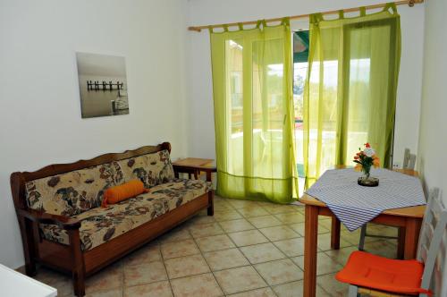 a living room with a couch and a table at Studios & Appartments Posidonio in Klíma