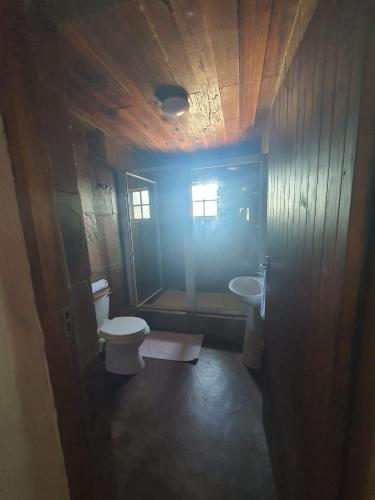 a bathroom with a toilet and a sink at Rain Farm Game Lodge in uMhlali