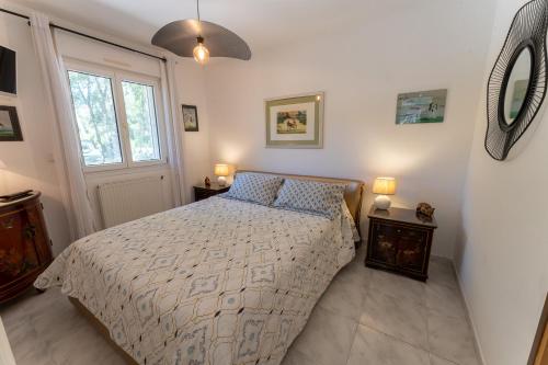 a bedroom with a bed and a mirror on the wall at T2 Au coeur des chênes 1831 route de Mazaugues in Saint-Maximin-la-Sainte-Baume