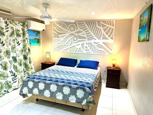 a bedroom with a bed with blue pillows at Seven Star Lodge in Port Vila