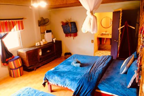 a bedroom with a bed with a blue comforter at La Beauté Bắc Hà in Bắc Hà