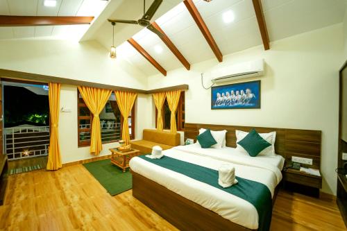 a bedroom with a large bed in a room at Coconut Greenland Resort in Nagaon