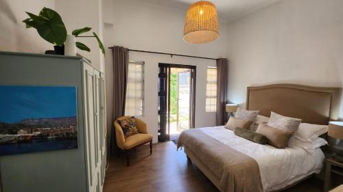 1 dormitorio con 1 cama, 1 silla y 1 ventana en Harbour Delight & Harbour Comfort, en Ciudad del Cabo
