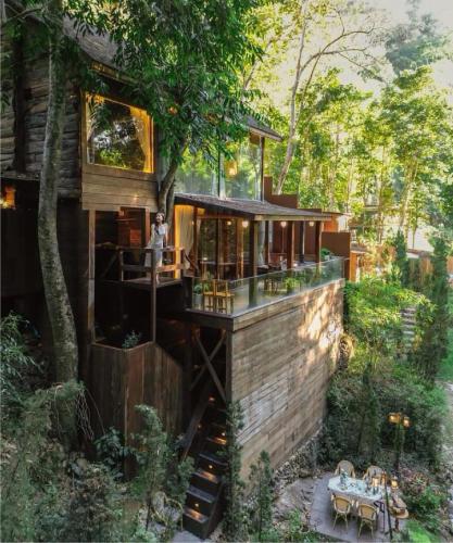 a tree house in the middle of a forest at Cliffver คลิฟฟ์เวอร์ in Chiang Mai