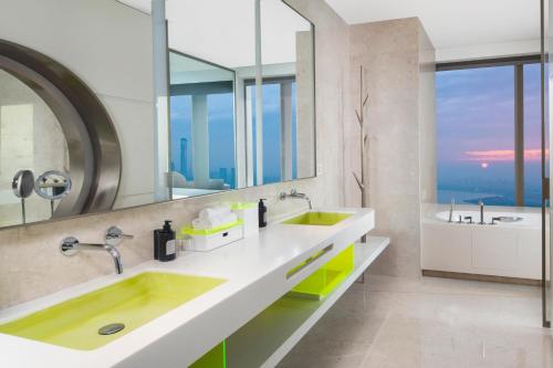 a bathroom with two sinks and a large mirror at W Suzhou - Jinji Lake in Suzhou