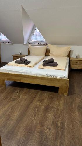 a bed with two pillows on it in a room at Pension Restaurant Pizzeria Lion in Krummhörn