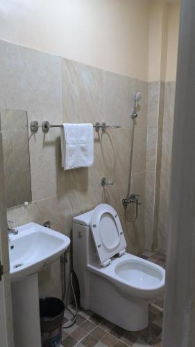 a bathroom with a toilet and a sink at Eva's Guest House in Bais