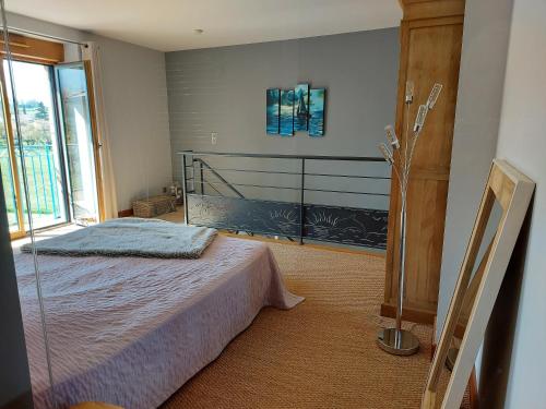 a bedroom with a bed and a large window at Gite Stone & Spa in Chasselay