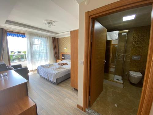 a hotel room with a bed and a bathroom at Avşa Blue Sea Otel in Marmara