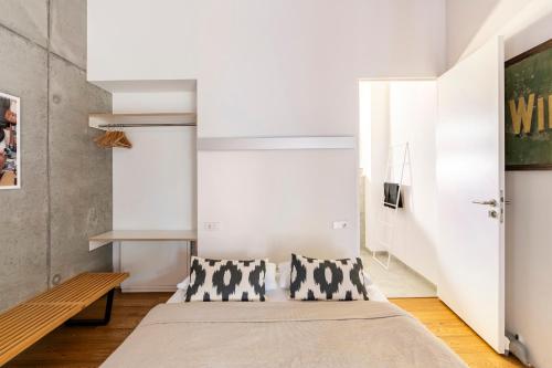 a bedroom with a bed and a bench at FRIZ Holiday Apartments in Gundelfingen