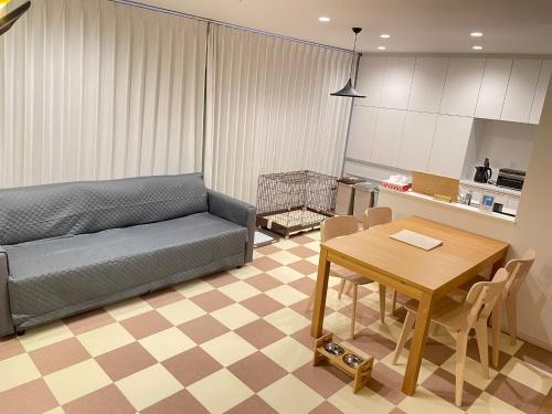 a living room with a couch and a table at 【ペット可】Niseko STREAM Villas in Rankoshi