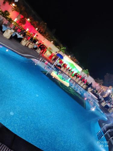 a view of a swimming pool at night at Hotel Royal Palace in Sāgar