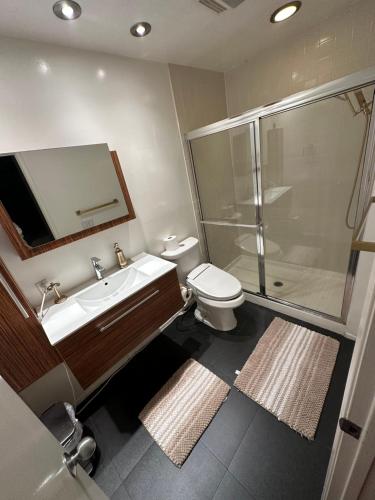 a bathroom with a toilet and a sink and a shower at Cozy Private Condo near Hall of Fame in Hollywood in Los Angeles